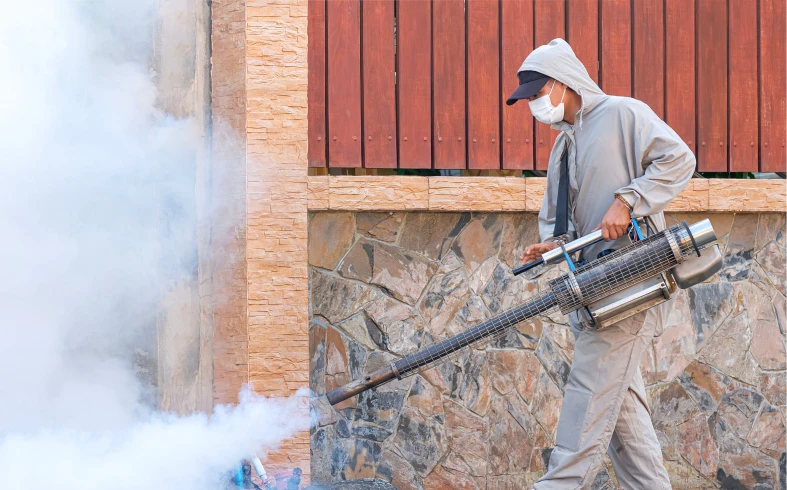 Person using fogging machine for pest control
